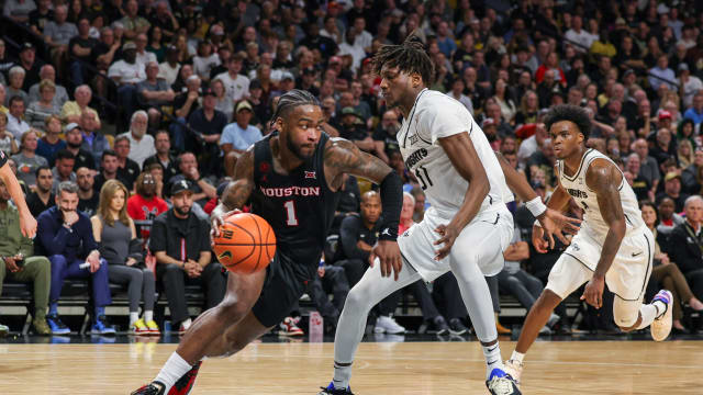 Mar 6, 2024; Orlando, Florida, USA; Houston Cougars guard Jamal Shead (1) drives around UCF Knights forward Thierno Sylla (31) during the second half at Addition Financial Arena. Mandatory Credit: Mike Watters-USA TODAY Sports  